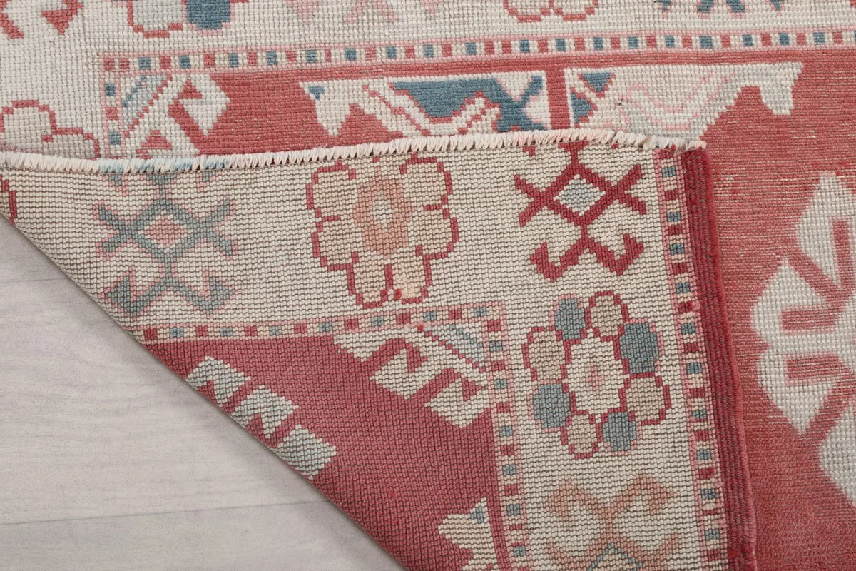 Close-up of the rug's fringe and a folded corner, showing the texture and construction.