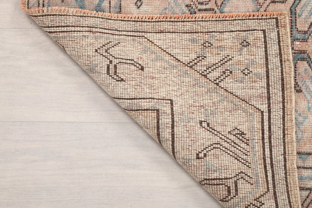 Another folded corner shot revealing the reverse side of the hand-knotted rug