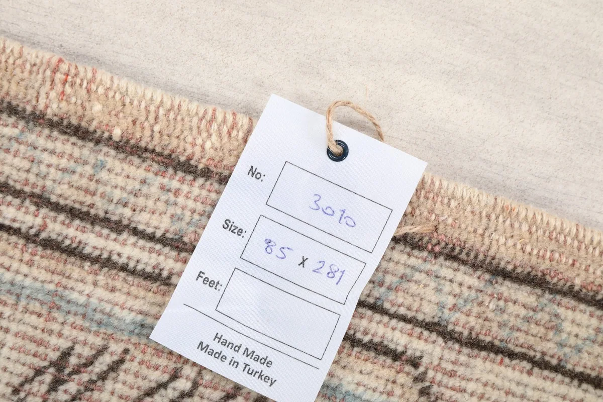 Tag showing the rug's dimensions in centimeters and 'Hand Made in Turkey'