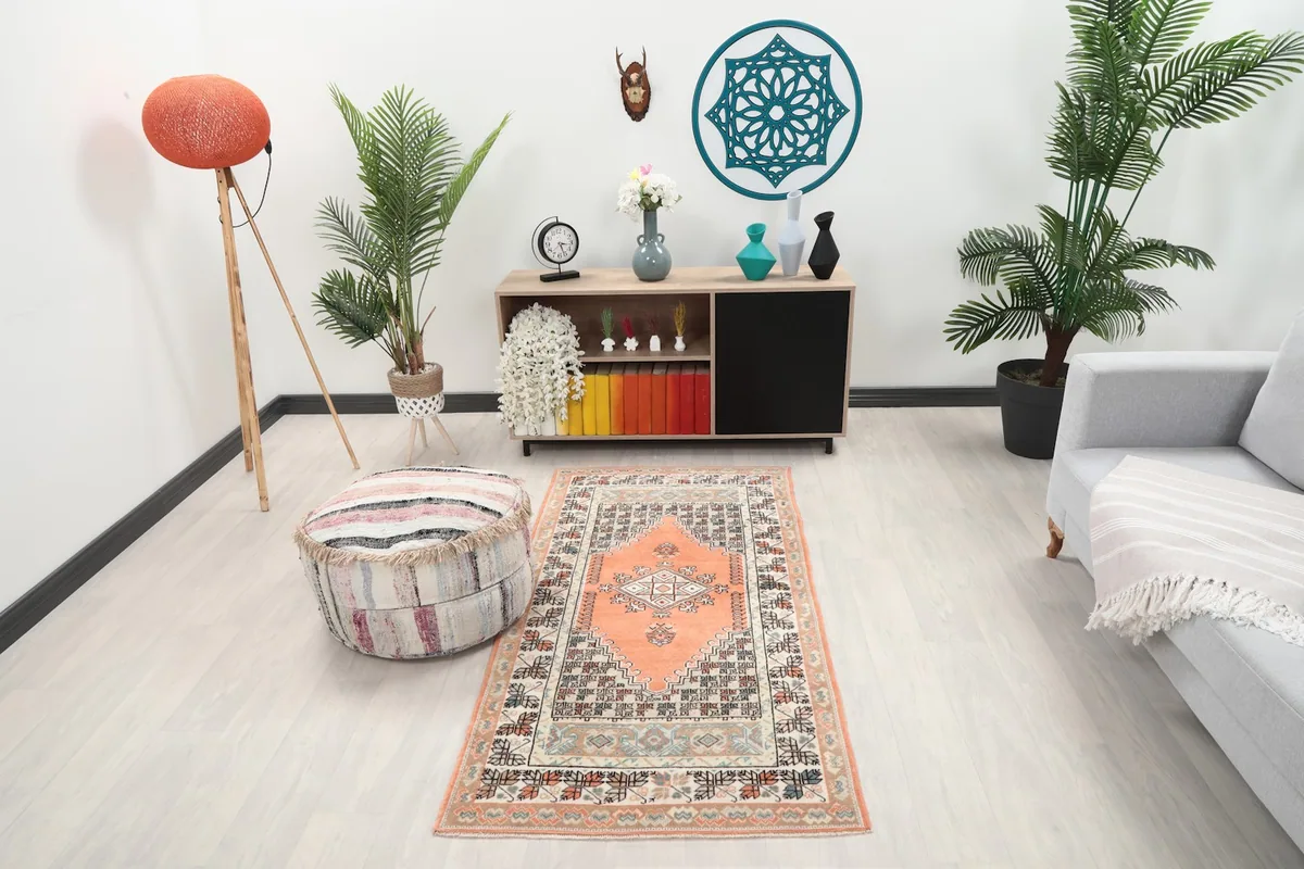 Orange vintage rug displayed in a living room setting with modern furniture