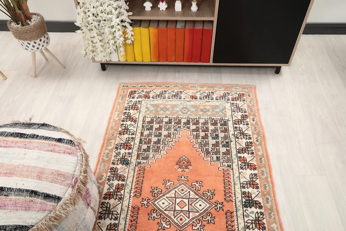 Overhead view of the orange rug in a room, showcasing its full design and scale