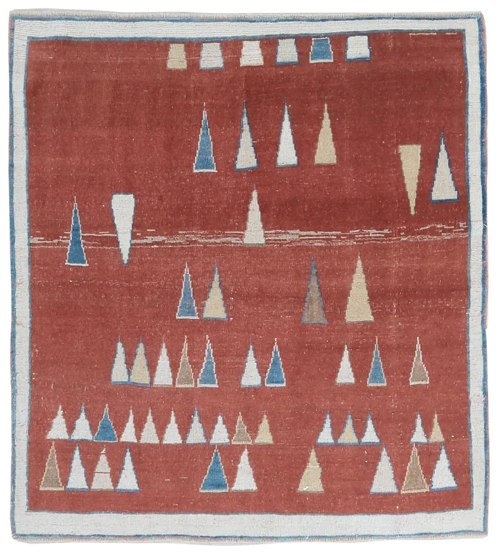 Full top view of the Rust Geometric Anatolian Rug, showing its geometric triangle motifs on a rust background.