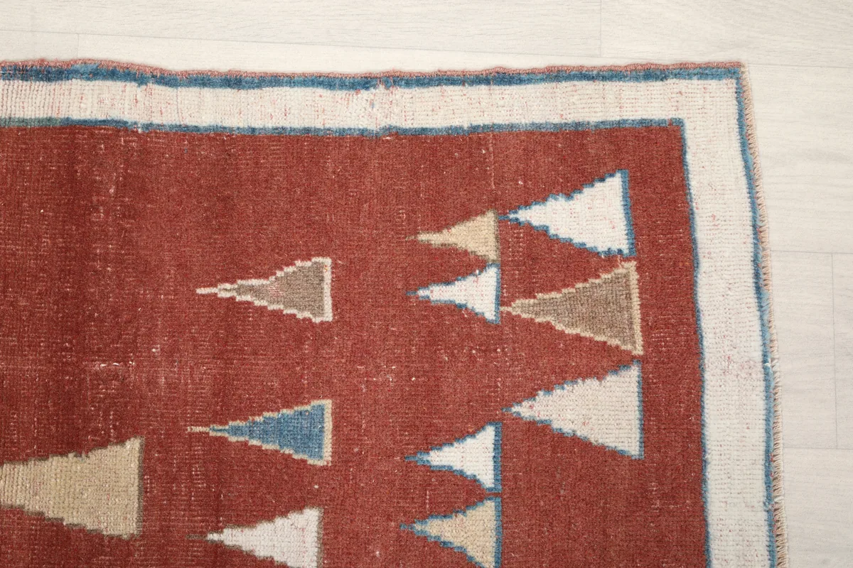 Close-up detail of the Rust Geometric Anatolian Rug's border and a section of the main field pattern.