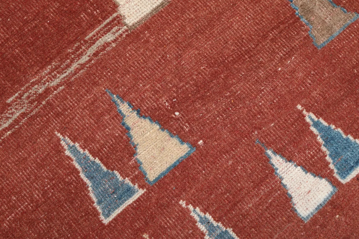Detail showing the low pile and texture of the hand-knotted Rust Geometric Anatolian Rug.