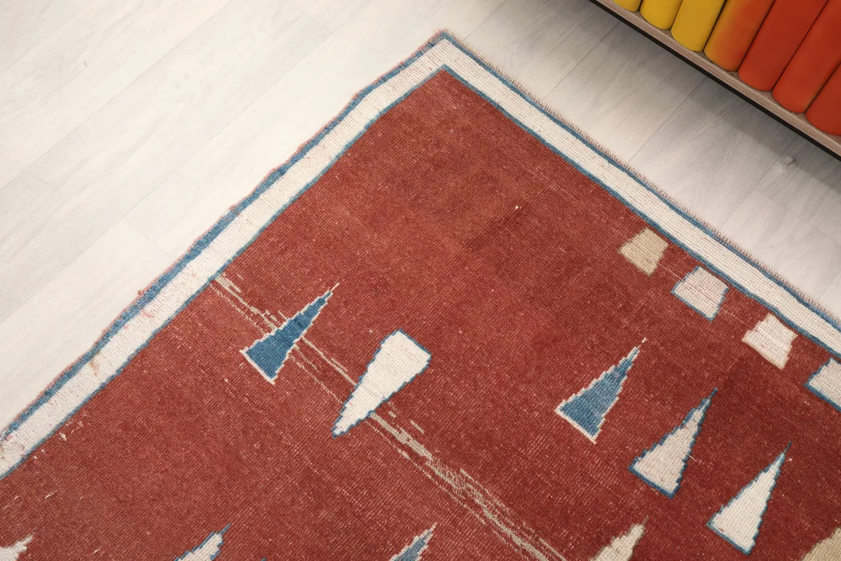 Close-up of the upper left corner of the Rust Geometric Anatolian Rug, showing border and motif details.