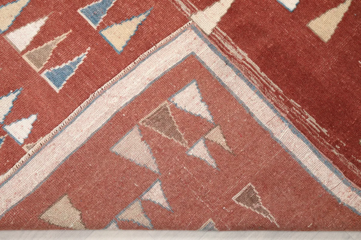 View of the back of the Rust Geometric Anatolian Rug, showing the hand-knotted construction and cotton foundation.