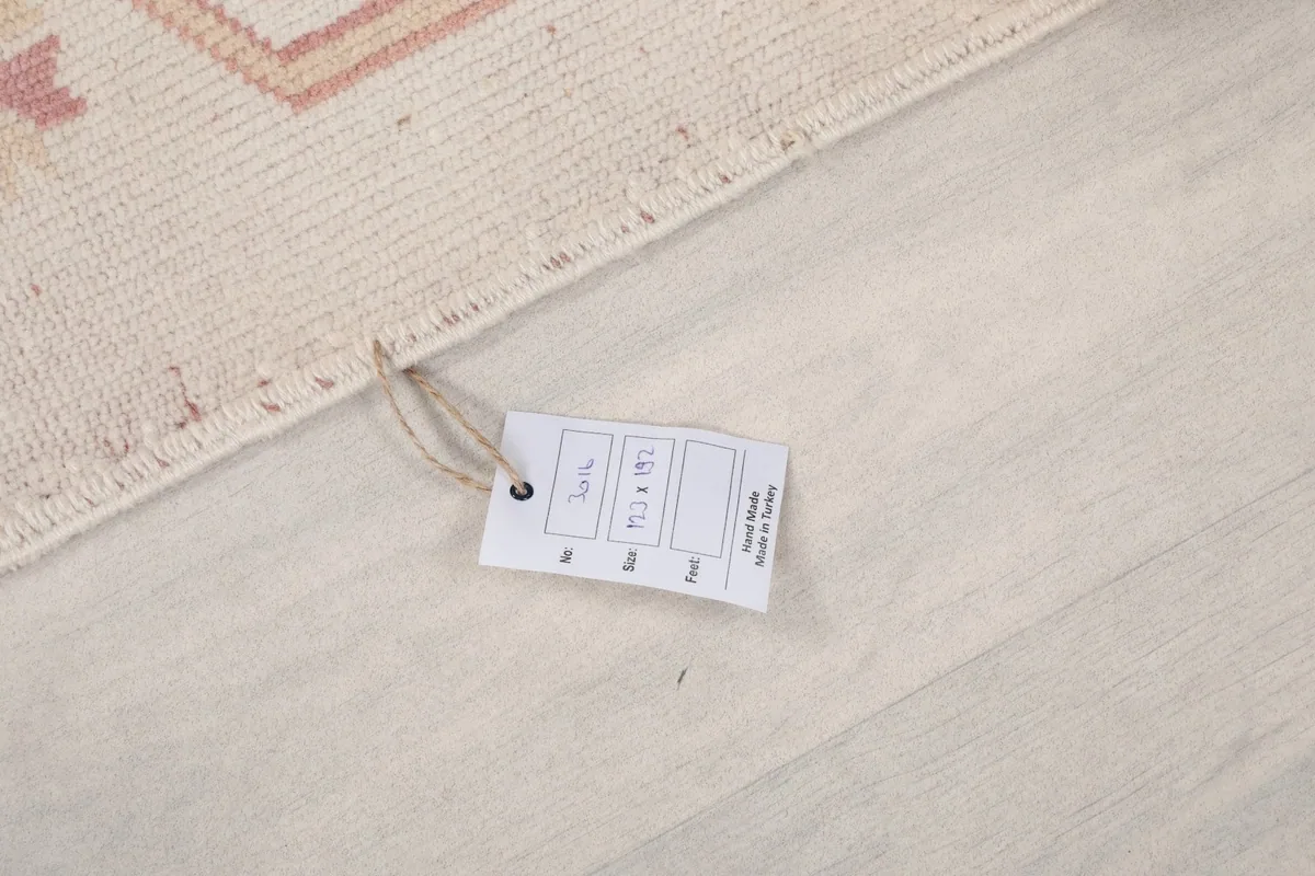 Product tag on the rug, displaying size information and origin details.