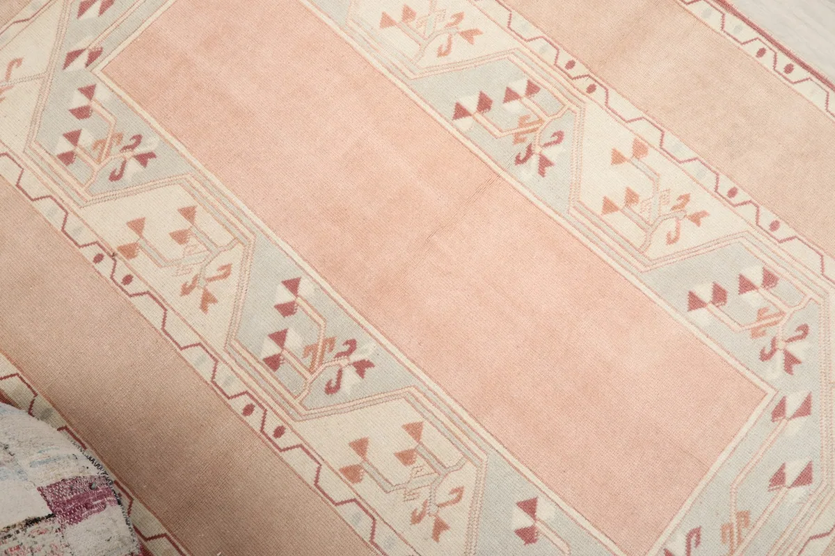 Angled view highlighting the geometric designs and color variations across the rug's surface