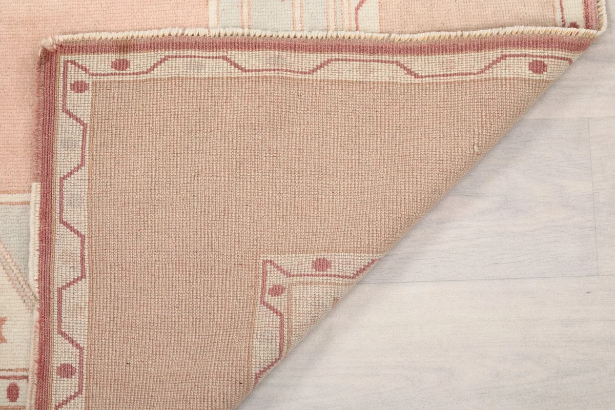 Close-up of the underside of the rug, revealing the tight knotting and foundation