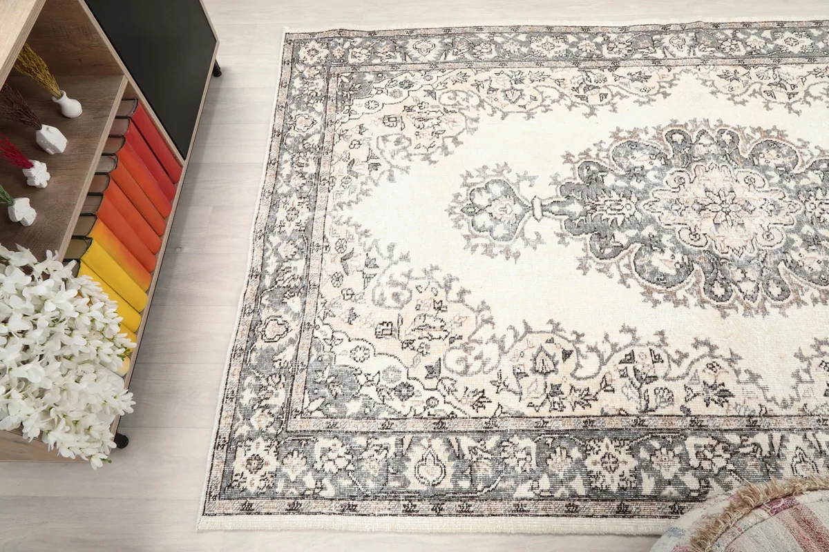 Angled shot of the rug's surface, capturing the overall design and patina
