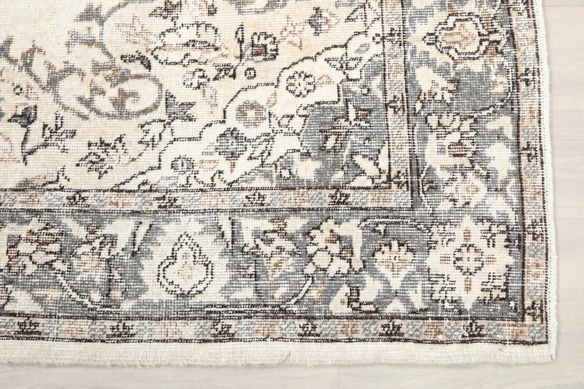Detailed view of the corner border pattern in gray and tan tones