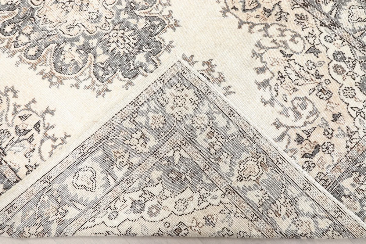 View of the rug's underside and pile, showing the cotton foundation
