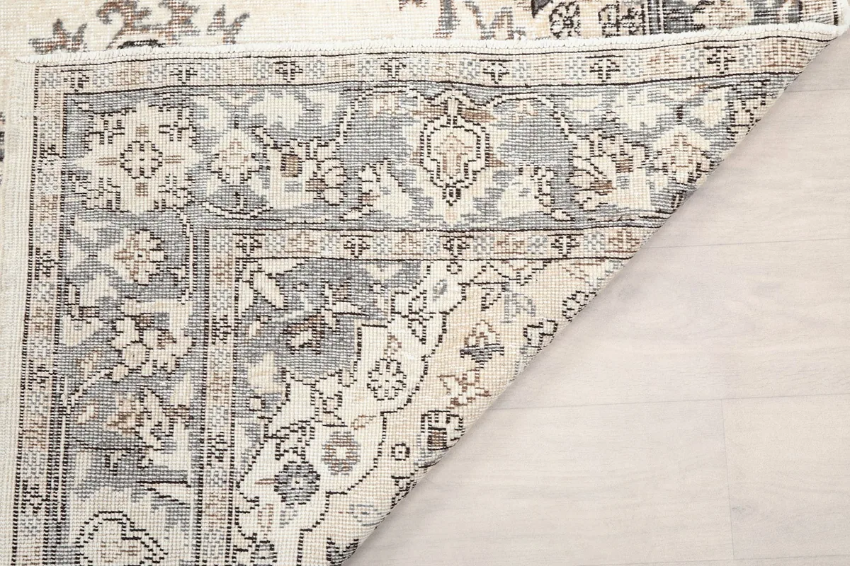 Close-up of the rug's back, revealing the hand-knotted construction