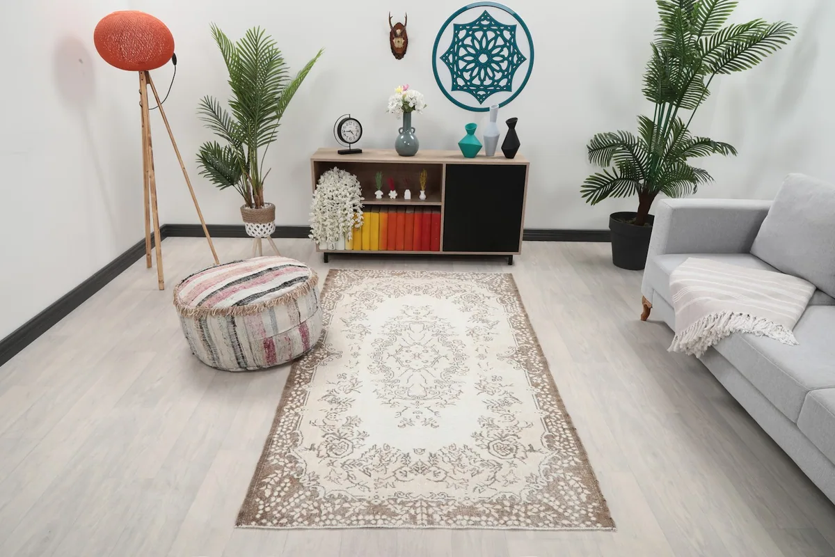 Ivory and brown vintage rug placed in a modern living room setting