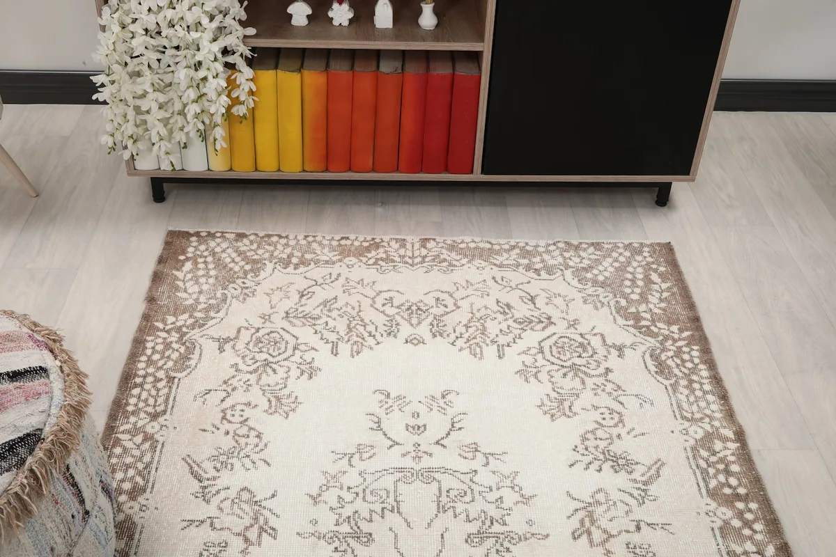Overhead view of the rug in a room, highlighting its position near a cabinet