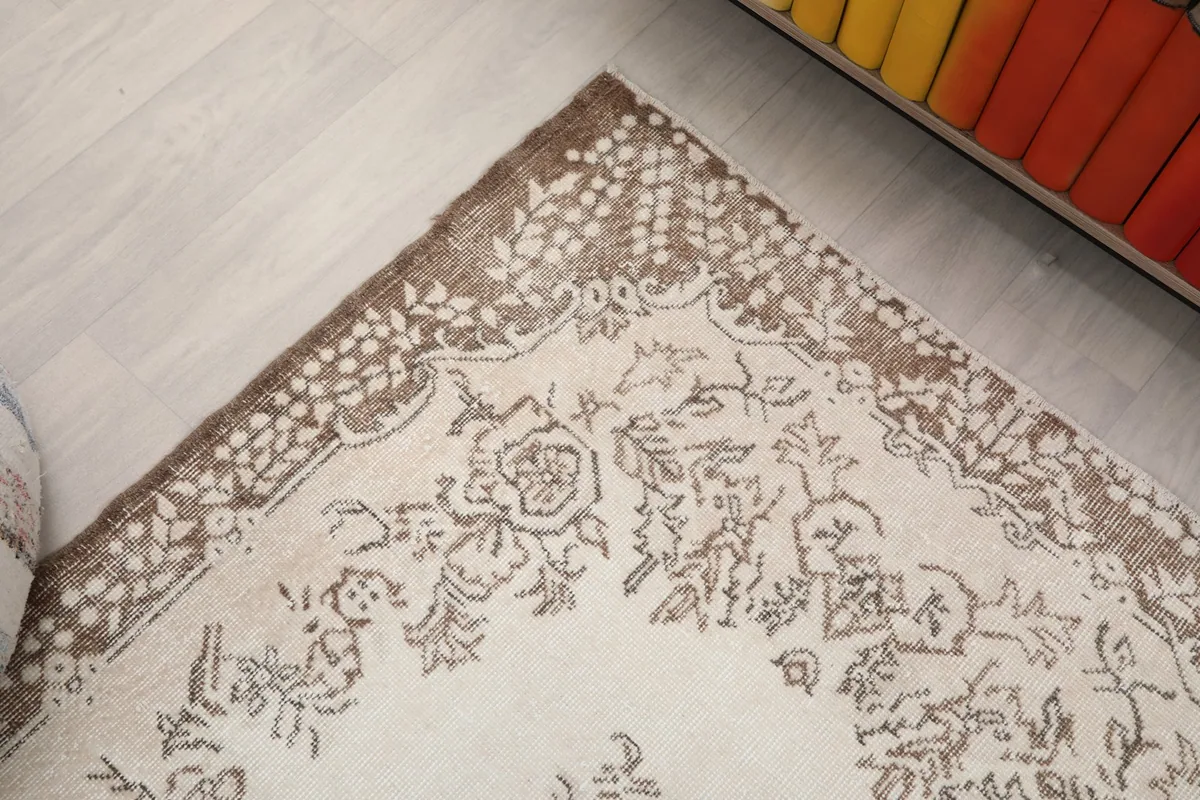 Corner detail of the rug showing the intricate brown border pattern