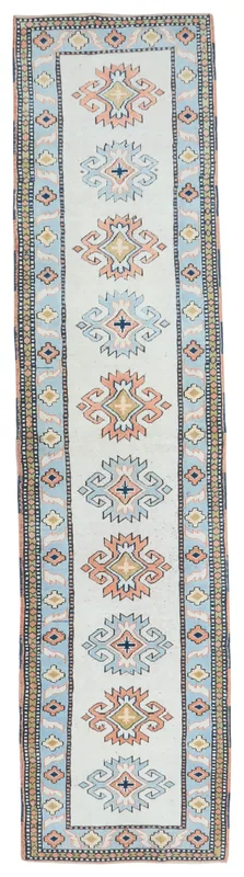 Full top view of the ivory, blue, and rose geometric vintage runner rug