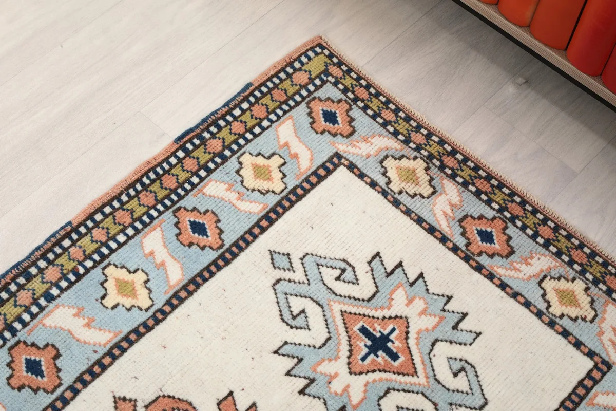 Corner detail of the rug's border, highlighting the intricate patterns and colors