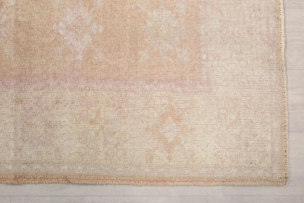 Detail of the rug's edge and faded geometric border design