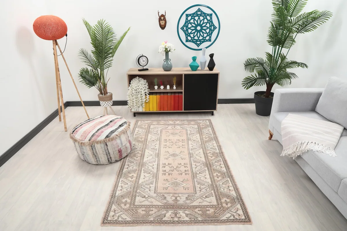 Vintage Anatolian rug displayed in a room setting with a sofa and side table