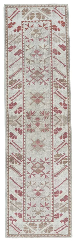 Full overhead view of the beige and rose geometric vintage runner rug