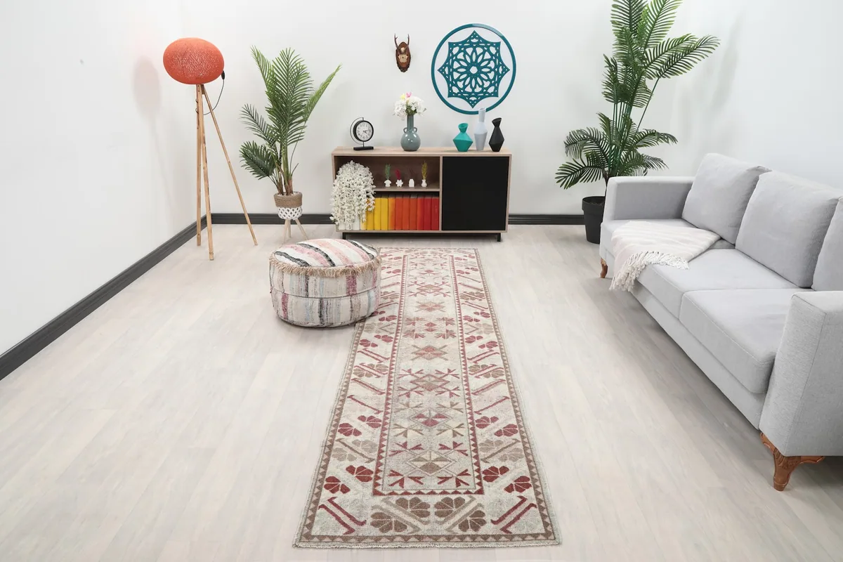 Vintage runner rug in a living room setting with a sofa and plants
