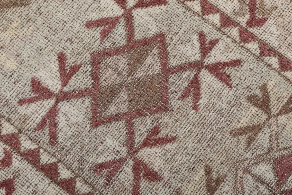 Close-up of the hand-knotted wool pile and specific tribal motifs