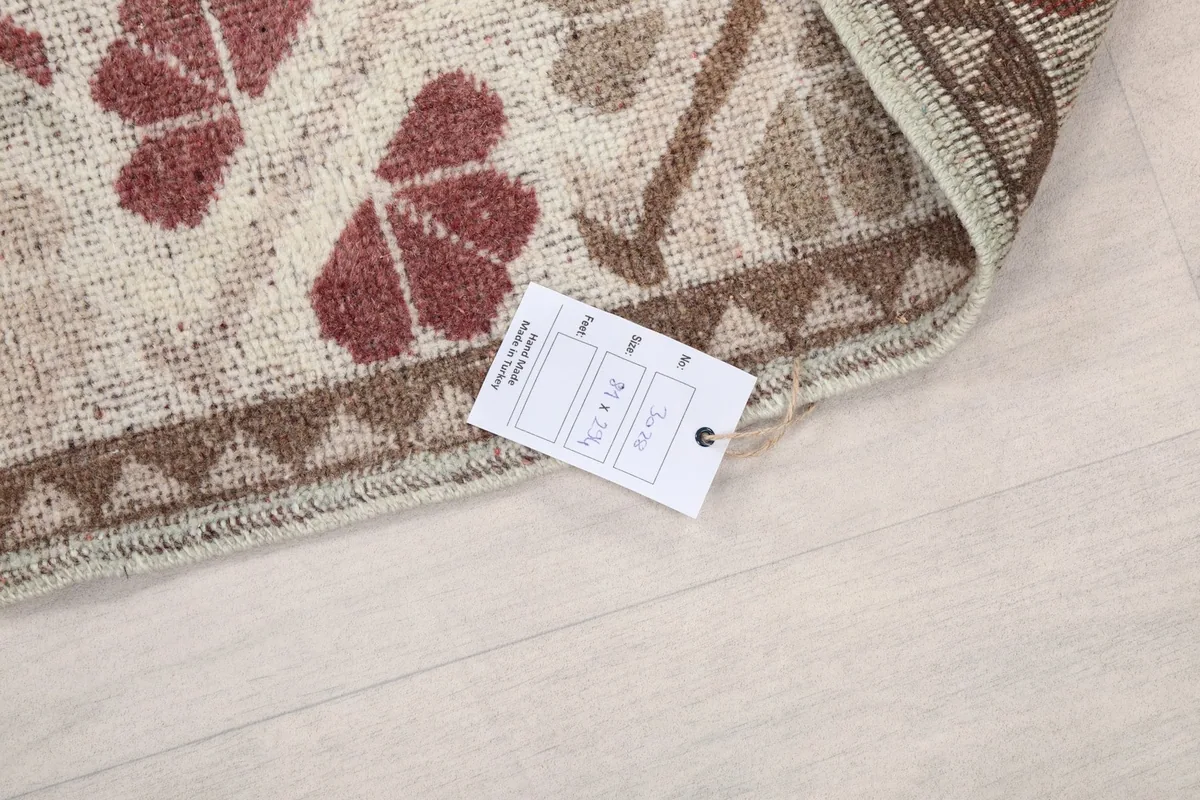 Close-up of the rug's label with size information, showing the edge and fringe