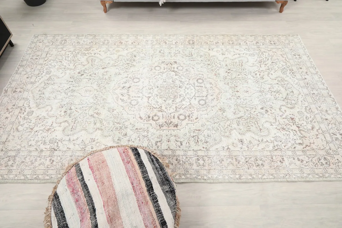 Full overhead view of the ivory medallion floral rug in the room, displaying its overall design.