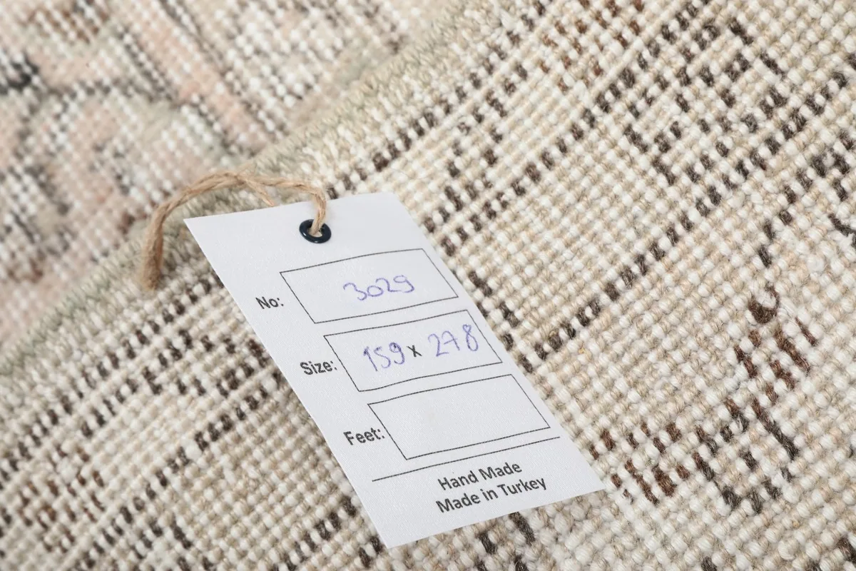 Tag displaying the rug's item number and size in centimeters, confirming it is handmade in Turkey.