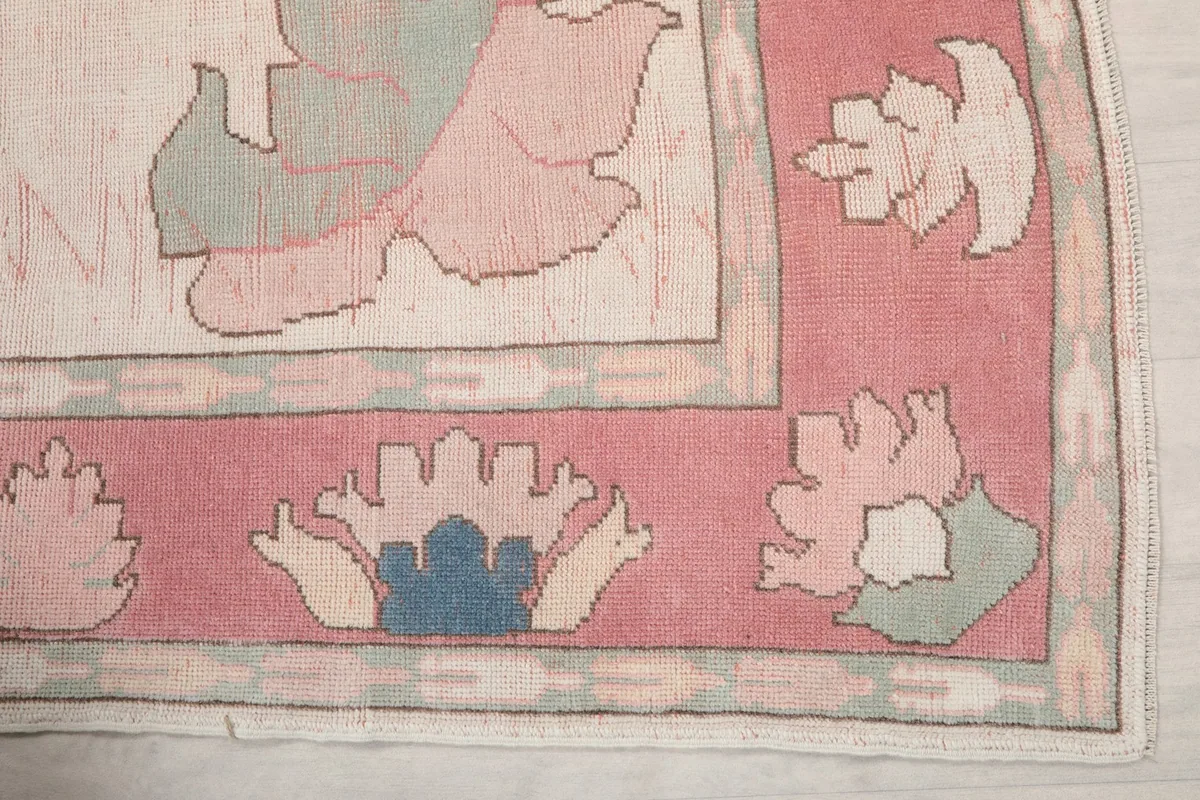 Detail of the rose border and ivory field, showing blue and green floral motifs