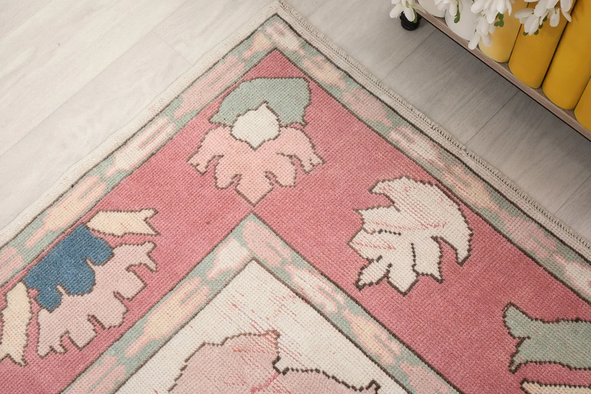 Corner detail of the rug's rose border and intricate floral and geometric patterns