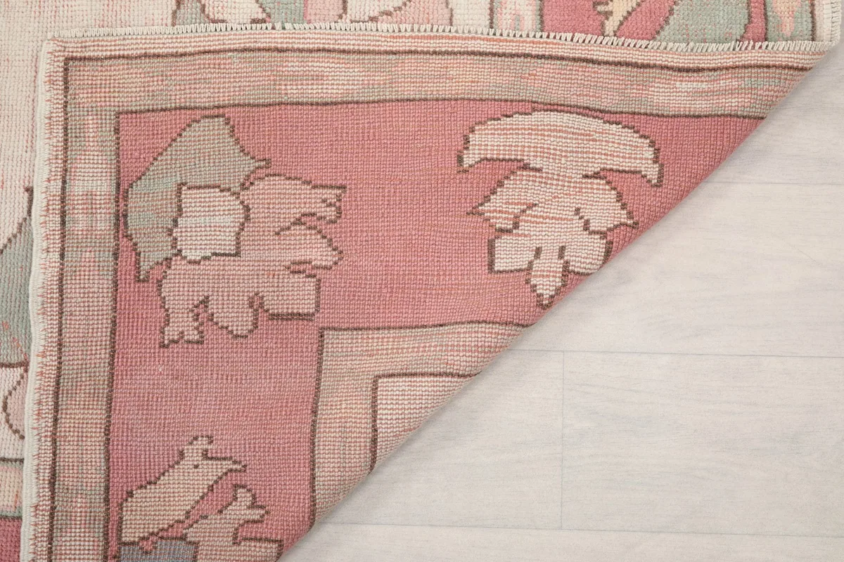 Another view of the folded rug corner, highlighting the weave and fringe