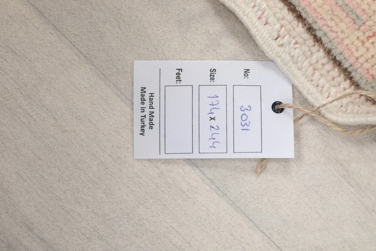 Product tag on the rug, showing size in centimeters and origin