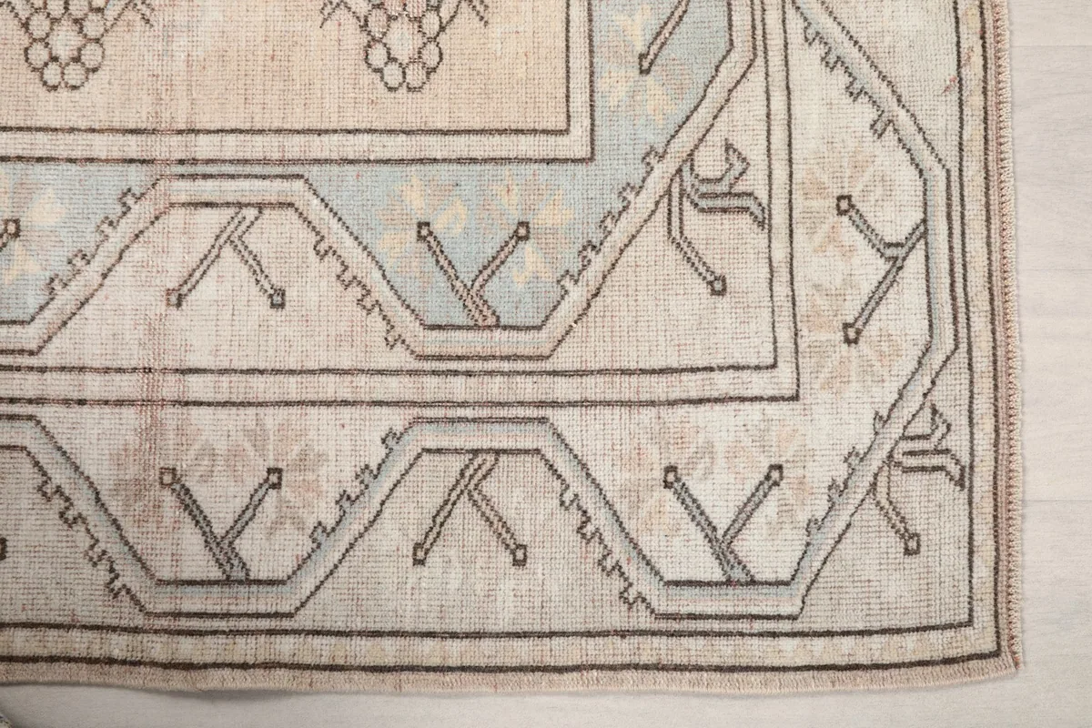 Detailed view of the corner border design with charcoal lines and subtle blue accents.