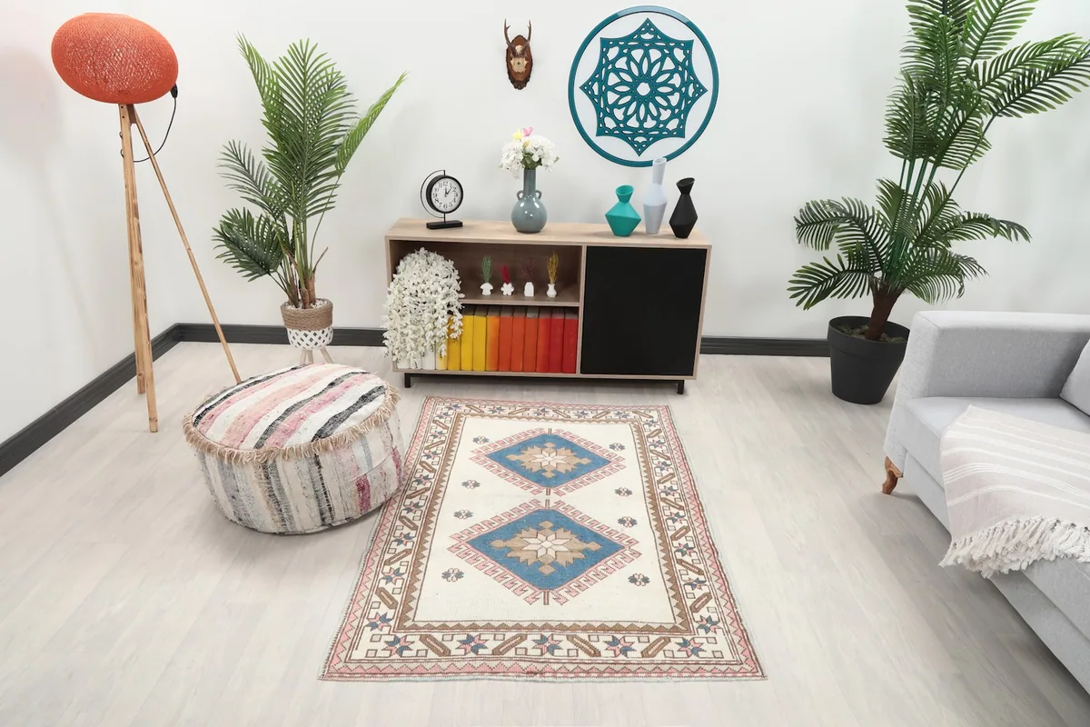 Vintage Anatolian rug in a living room setting with a sofa and plants