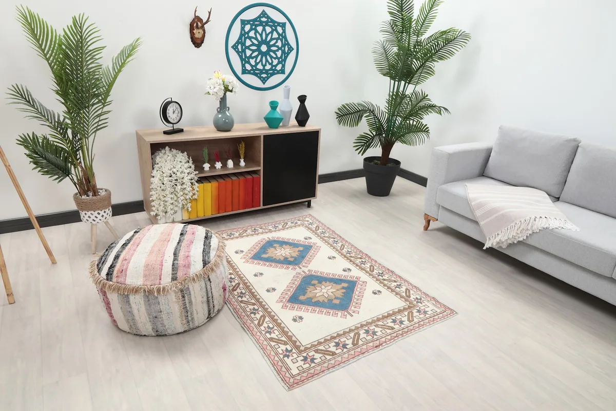 Ivory and blue vintage rug displayed in a bright room with contemporary furniture