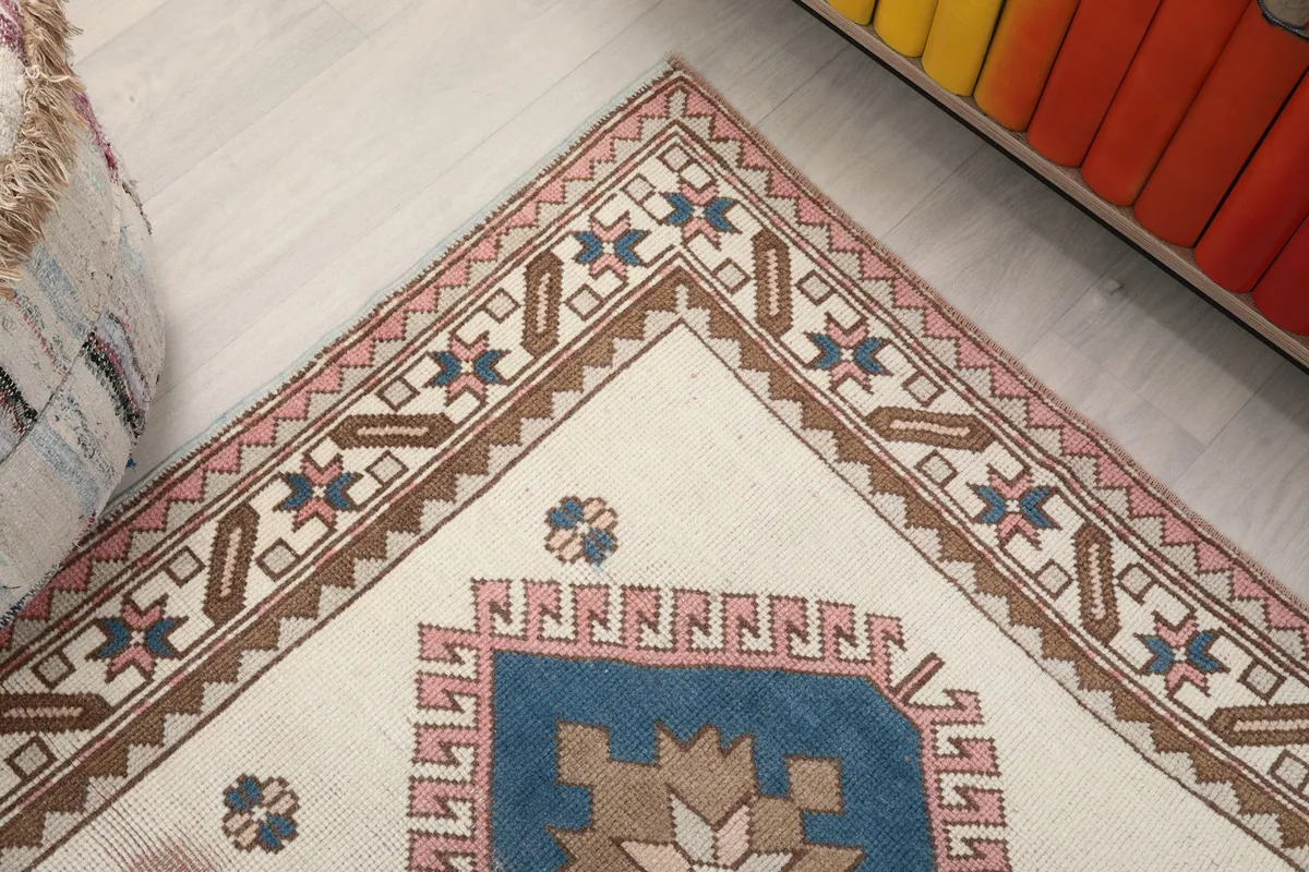 Close-up of the rug's top corner, showcasing the intricate border and field patterns