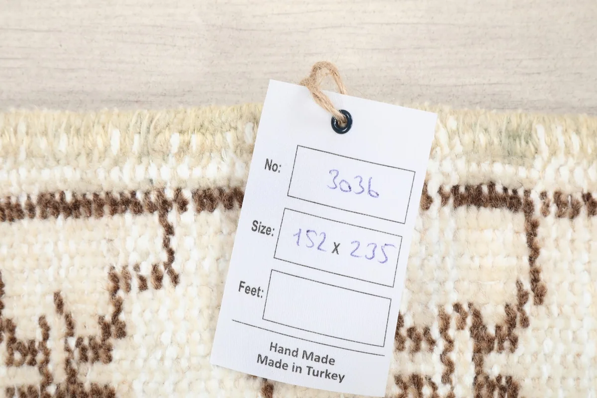 Product tag on the rug showing size in centimeters and 'Hand Made in Turkey'