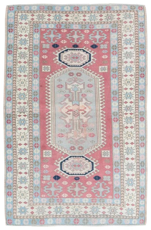 Full overhead view of the rose and blue vintage Anatolian rug with geometric medallion