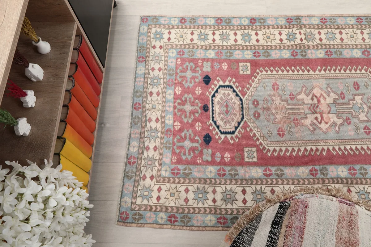 Overhead angled shot of the rug in a room, capturing its texture and colors from above