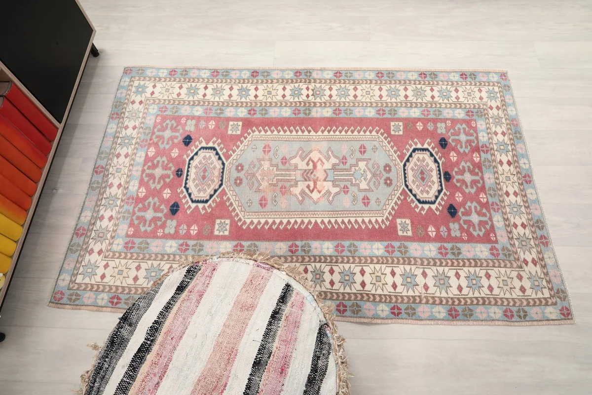 Full overhead view of the vintage rug, showing its rectangular shape and design