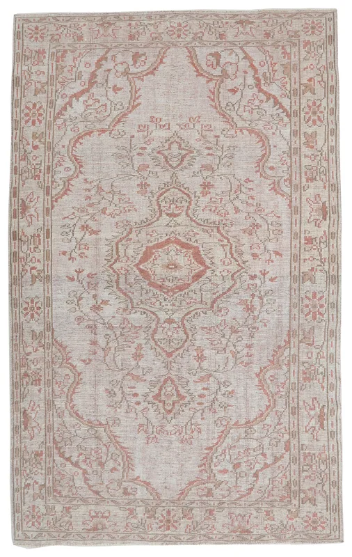 Full overhead view of the beige and rose vintage Anatolian rug on a white background