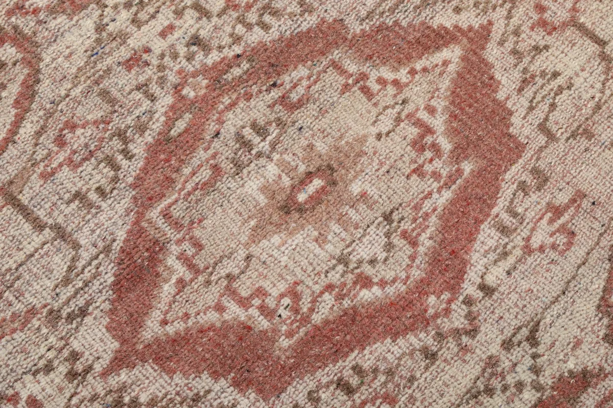 Macro view of the hand-knotted wool pile, showing texture and color variations of the rug