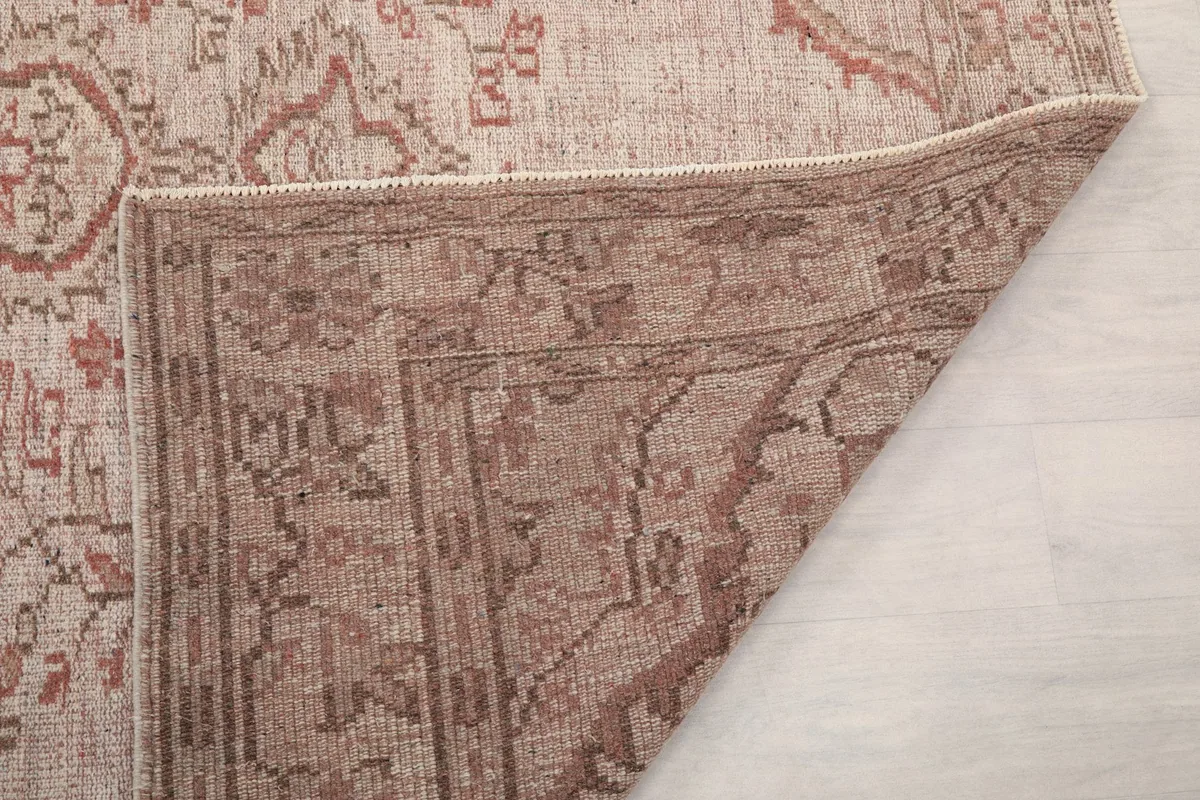 Close-up of the back of the rug, showing the intricate hand-knotting and foundation material