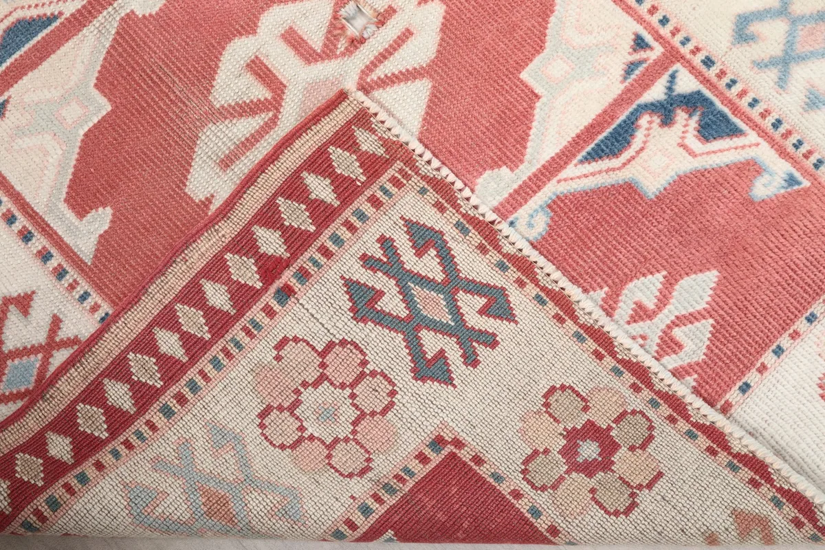 View of the back of the rug, showing the hand-knotted construction and wool pile