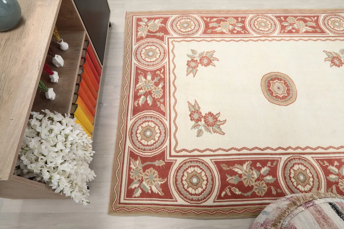 Angled view of the rug, showing its texture and color variations near a cabinet