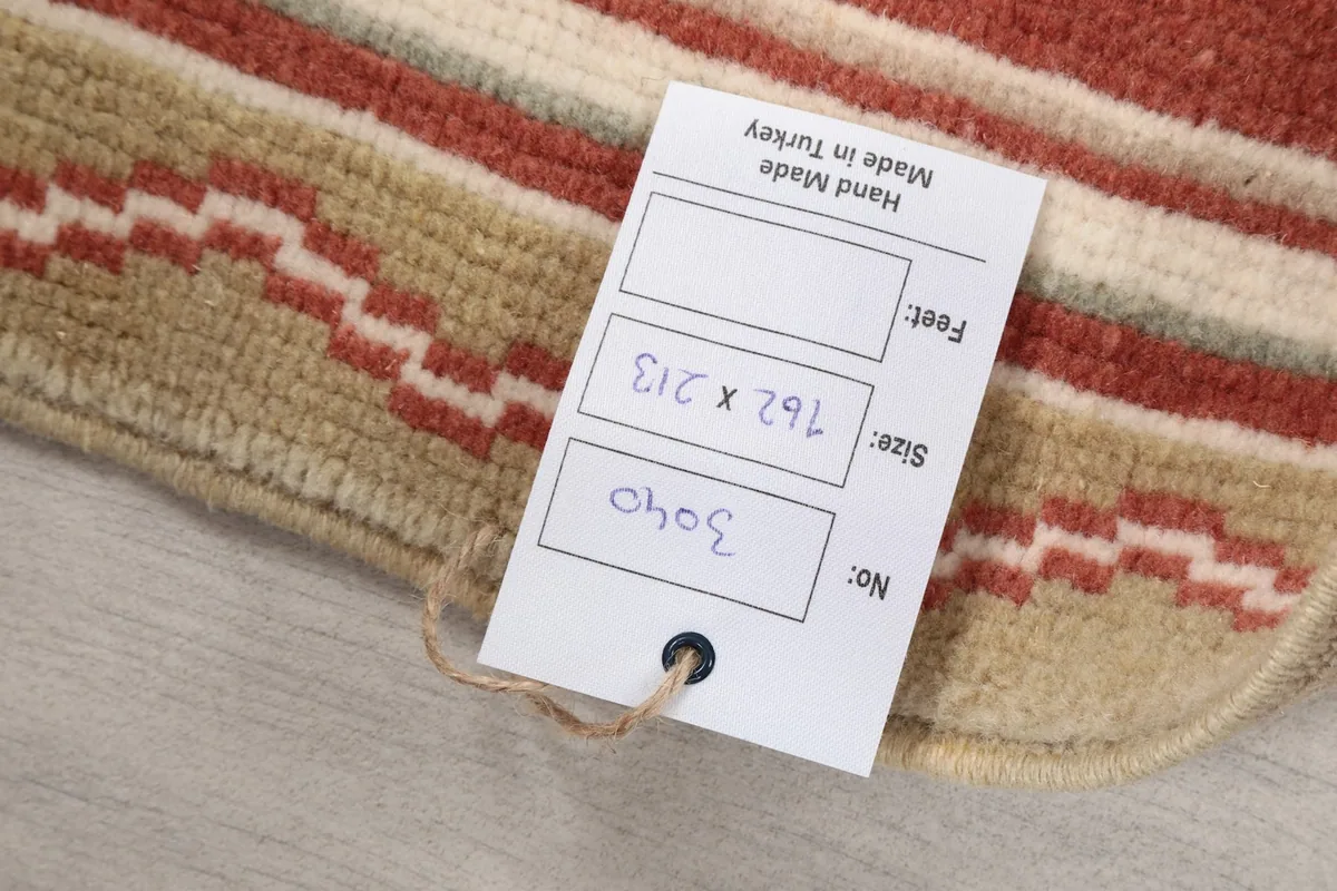 Close-up of the product tag showing the rug's dimensions and origin