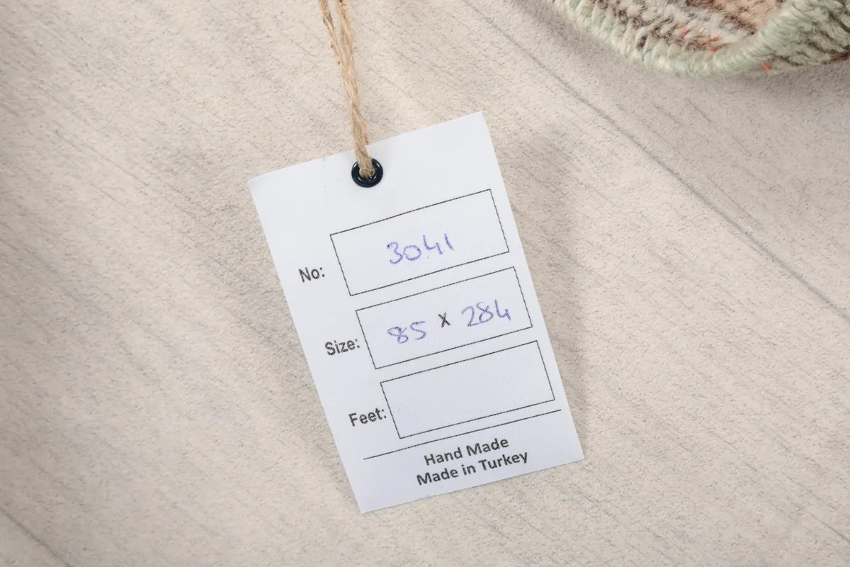 Product tag indicating the rug's number, size in cm, and origin from Turkey