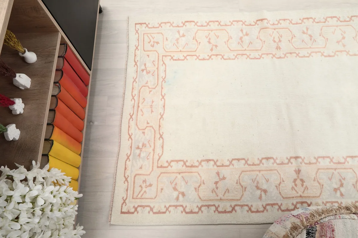 Angled view of the rug's full length, with decorative elements in the background